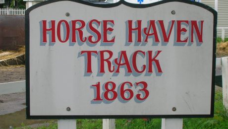 Red and gray old-timey letters on a white sign, reading "Horse Haven Track 1863"